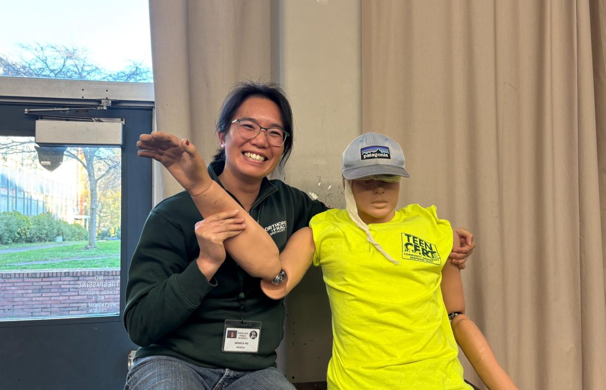 Monica Ng with IBW health training manikin, "Rico Rescue."