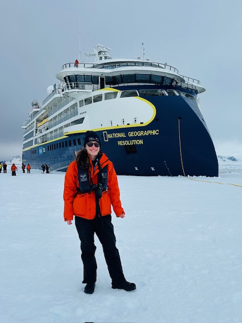 Hillary Brown stands in front of the National Geogprahic's Resolution, the ship she traveled on throughout Antarctica. Photo courtesy of Hillary Brown.
